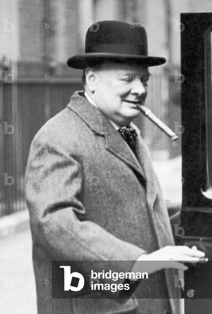 Winston Churchill pictured smoking a cigar, circa March 1938.