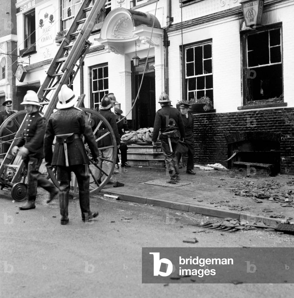 Firemen bring out dead bodies from the Rose and Crown Hotel, Saffron Walden, after the fire which killed nine people. December 1969
