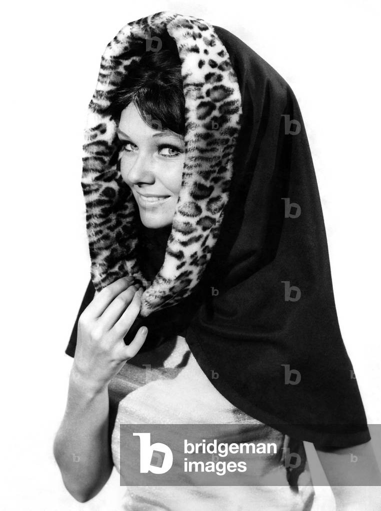 Model wearing a headscarf with leopard skin patterned lining. 
November 1962