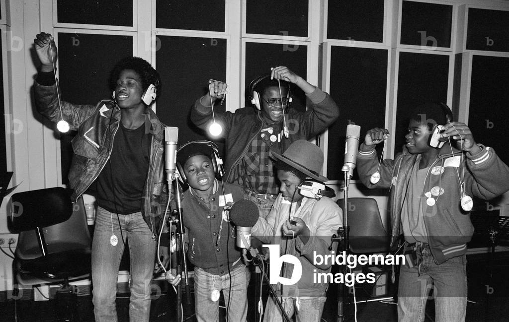 Musical Youth, British Jamaican pop / reggae group, at Capital Radio studios in London where they are helping to launch a road safety campaign involving glitter discs 8th October 1982 (b/w photo)