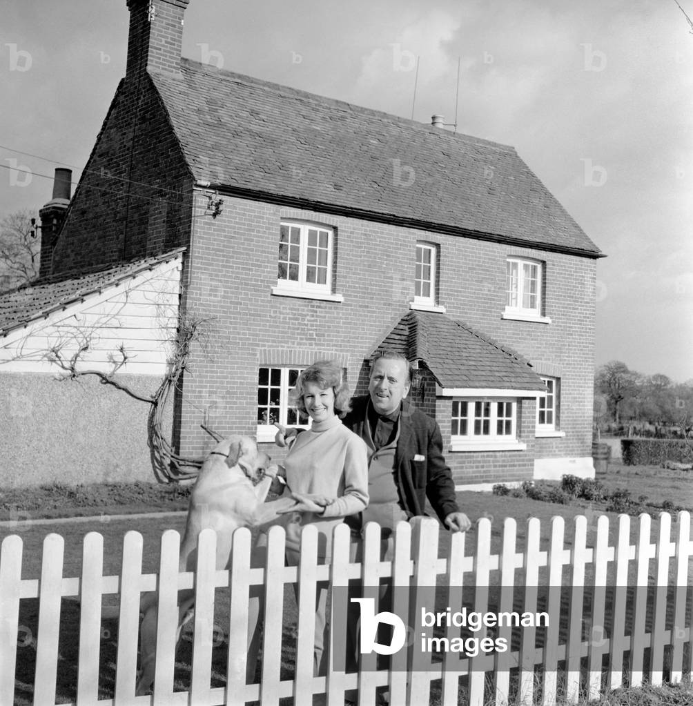 TV actor Hugh Lloyd seen here at home with his wife and pet dog, 1960 (b/w photo)