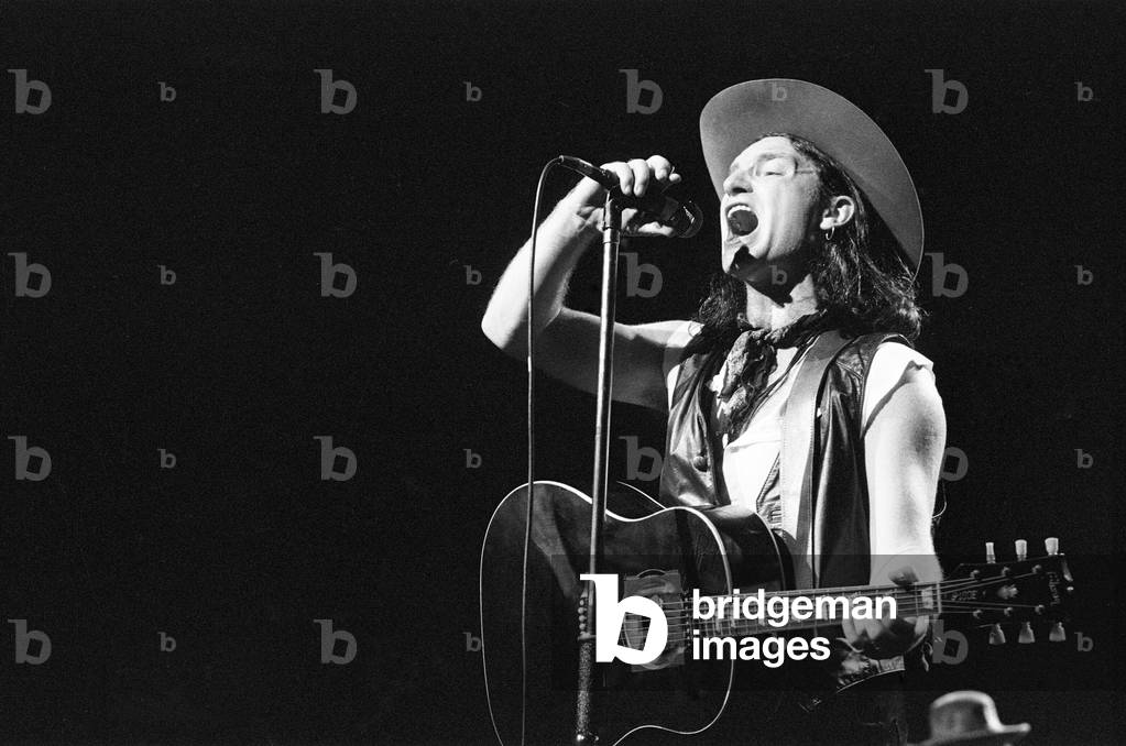 Rock group U2 performing on stage at the National Exhibition Centre in Birmingham. Pictured is lead singer Bono. 3rd August 1987 (b/w photo)