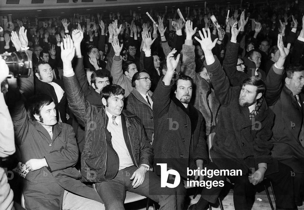 Striking workers at Ford Halewood factory in Liverpool make a vote with their hands during a meeting, April 1971 (b/w photo)