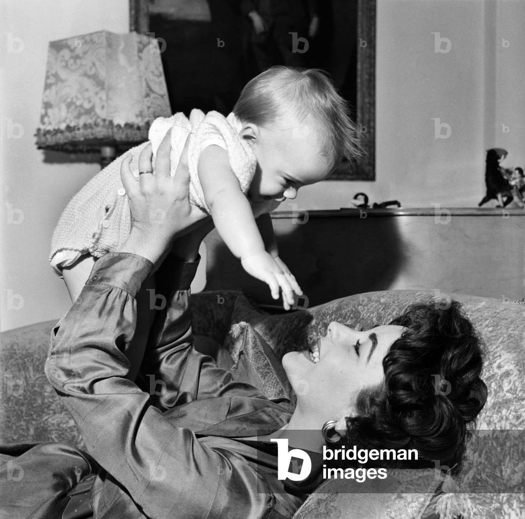 Actress Elizabeth Taylor at home with her baby son Michael. September 1953