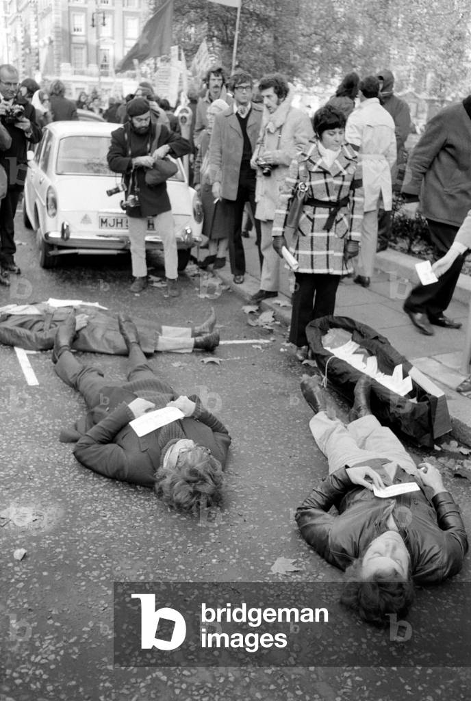 Extra police were on duty in case of trouble during today's anti-vietnam war demonstration outside the American Embassy in Grosvonor Square 
Cards bearing the names of American dead in Vietnam were dropped into a coffin outside the U.S. Embassy. 
In protest against the Vietnam dead, the demonstrators lie down beside the coffin - their name placards on their chests. 
November 1969