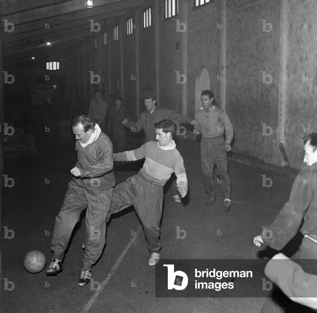 Football players train under one of the stands as snow prevents training at the Brittania Stadium, home of Stoke City, 16th January 1963 (photo)