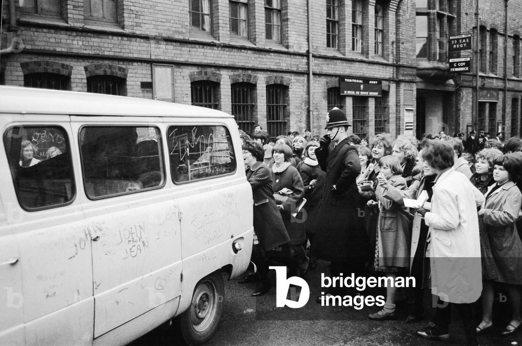 The Beatles leave Birmingham in a van surrounded by hundreds of screaming fans. 10th November 1963 (b/w photo)