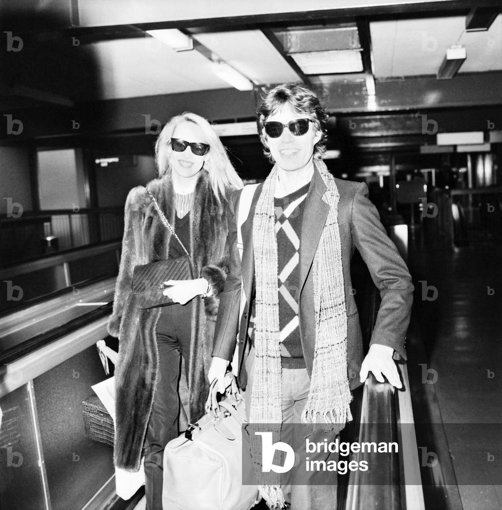 Rolling Stones. Mick Jagger and Jerry Hall leaving London Airport Heathrow for a Christmas Holiday in Barbados. 19 December 1982