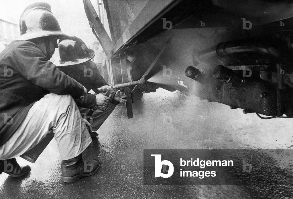 Firefighters put the blaze out on the burning lorry, 1970