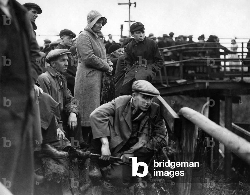 Workers and family members of missing miners anxiously waiting for news at the Pit-Head after the Colliery disaster at Wrexham.