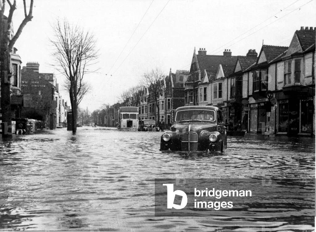 Cardiff - Floods - A car picks it's way through the flood water at Neville Street, Cardiff - Dec 1960 (b/w photo)
