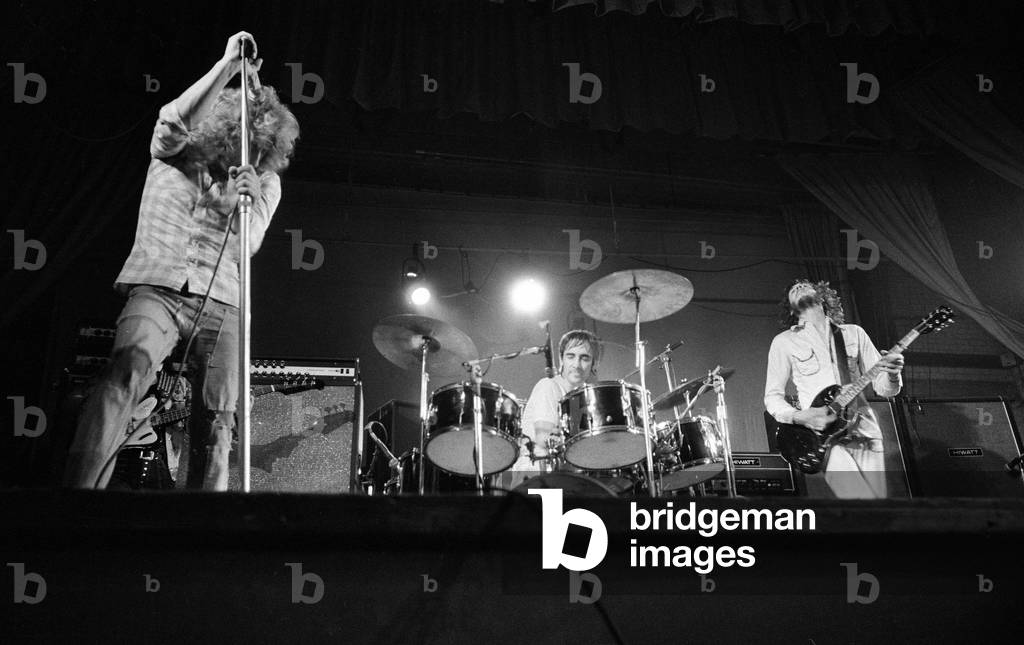 British rock group The Who performing on stage during a concert at the University of Reading.Singer Roger Daltrey with Pete Townshend on guitar and Keith Moon on drums. 2nd October 1971 (b/w photo)
