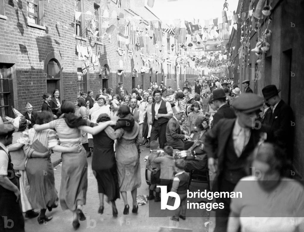 Street Party in London's East End in celebration of King George V Silver Jubilee, 3rd May 1935 (b/w photo)