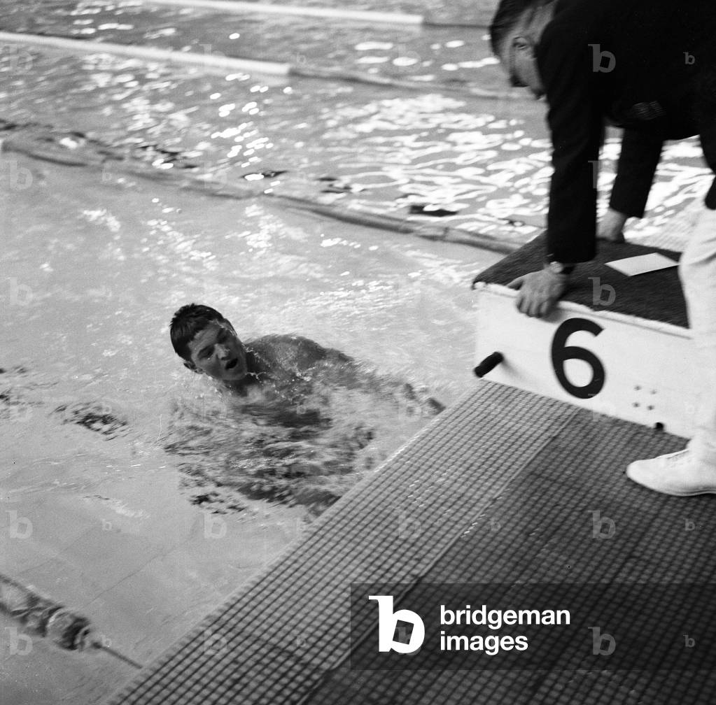 Ian MacIntosh Black, Scottish swimmer, pictured with coach, at the Empire Games, Cardiff, Wales, 25th July 1958.