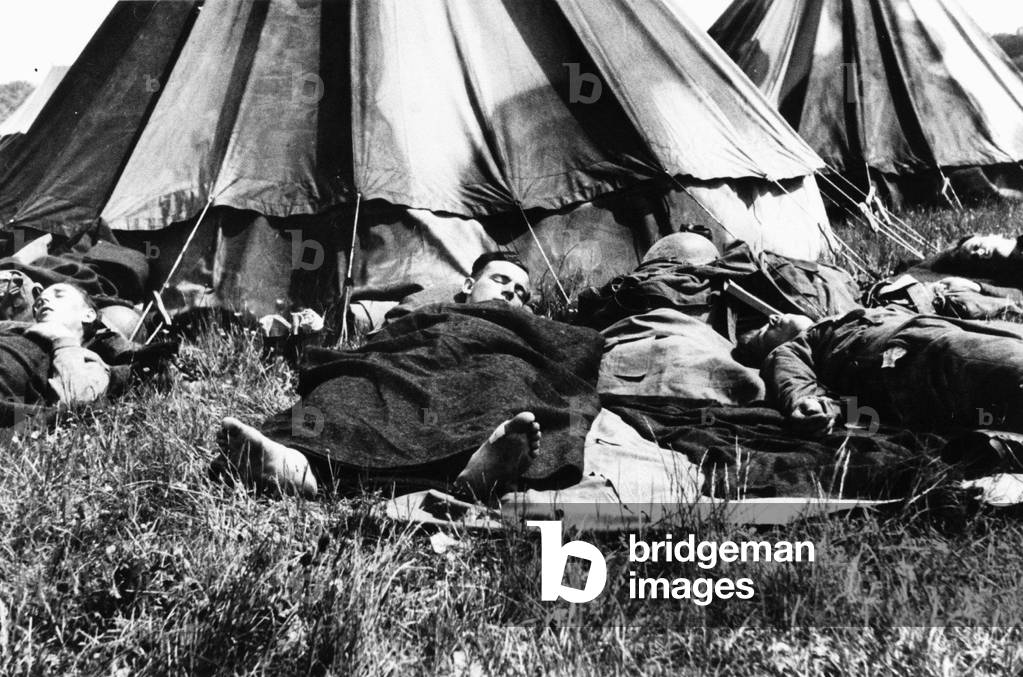Dunkirk Evacuation of BEF from Dunkirk, tired troops sleep in a camp after their return to England, June 1940 (b/w photo)