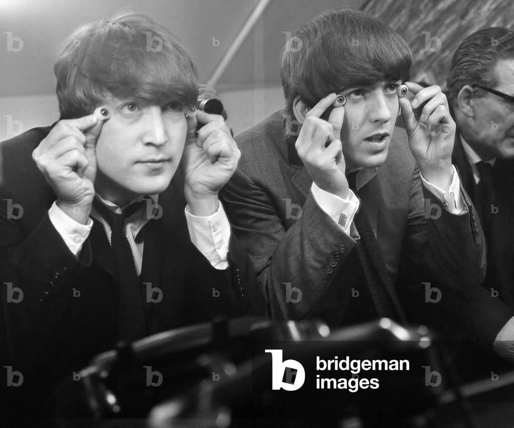 John Lennon and George Harrison with glass eyes when the Beatles' details were being taken for their Madame Tussauds waxworks during the making of 