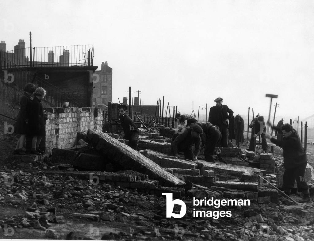 World War II Scotland Glasgow Clydebank Air Raid Two children watch workmen clear away rubble following the German air raid on the city, March 1941 (b/w photo)