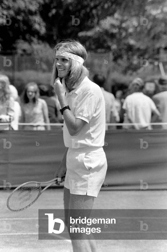 Wimbledon Tennis Championships 1970 1st Day. R.J. Moore (South Africa) complete with headband, in play against R.E. Homberg (U.S.A.) at Wimbledon today. June 1970