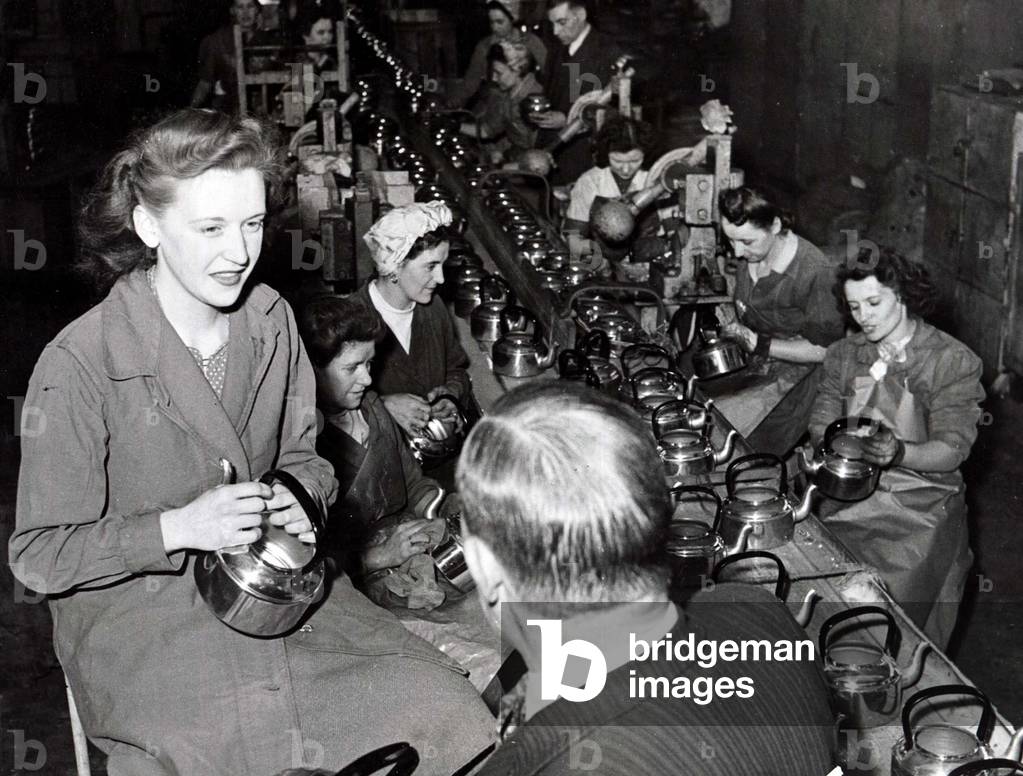 Aluminium pots, pans and kettles, by the million are being produced at this Neath South Wales factory, April 1949 (b/w photo)