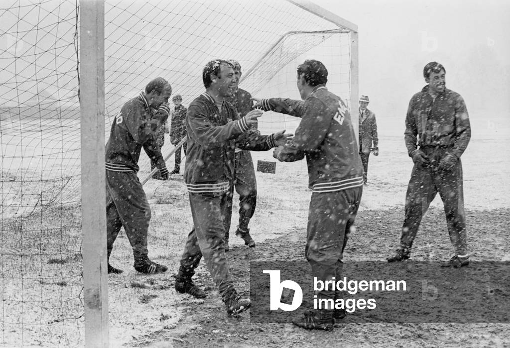 England footballer Jimmy Greaves laughs as he walks out the goal during a snow covered training session with the England squad in preparation for an International match at Wembley, with goalkeeper Gordon Banks and Bobby Charlton watching on. 2nd April 1968 (photo)