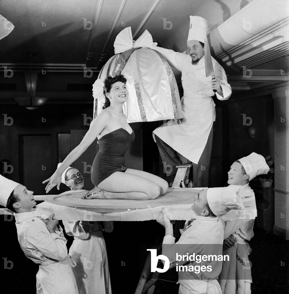 New Year Celebrations - Chefs at the Kensington Palace Hotel prepare a woman (Barbara Whitburn) in cake. December 1952 C6422
