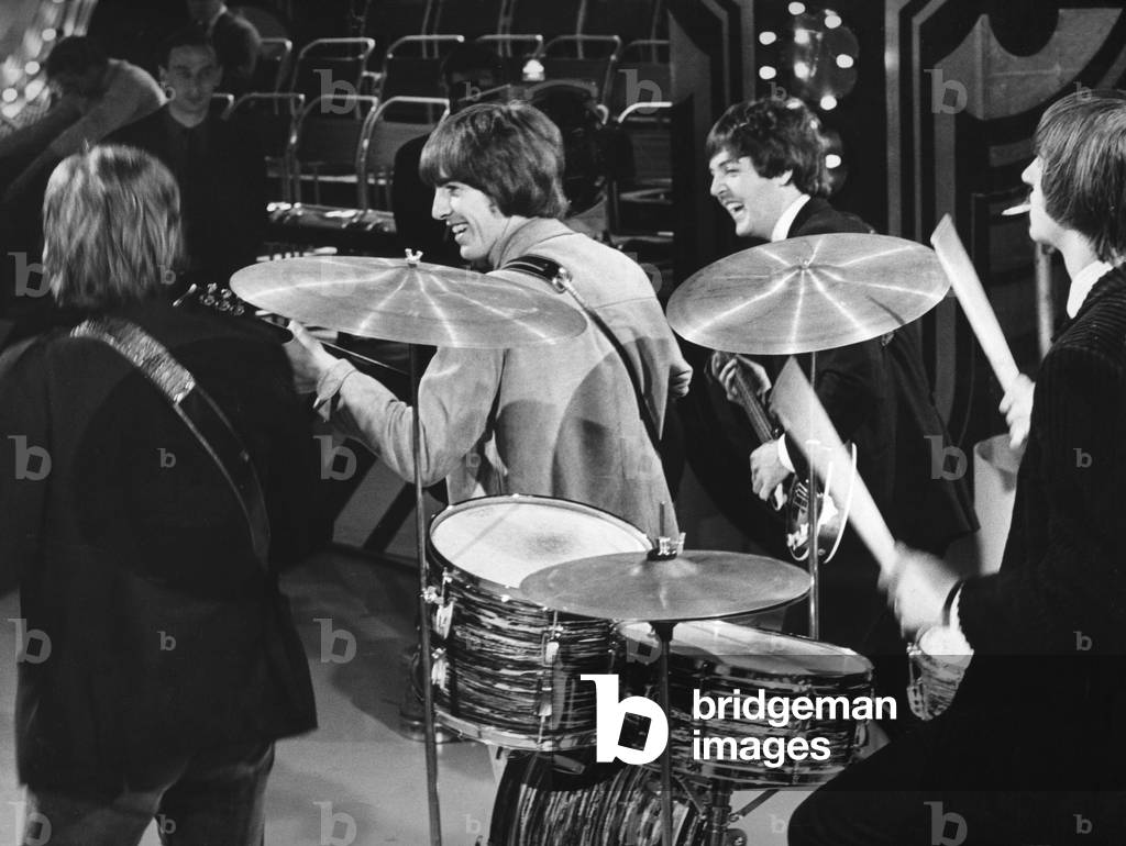 The Beatles... drummer Ringo smokes and Paul and George (centre) joke with John as the Beatles rehearse at alpha T.V. studios, Aston, Birmingham yesterday.
31-03-1965