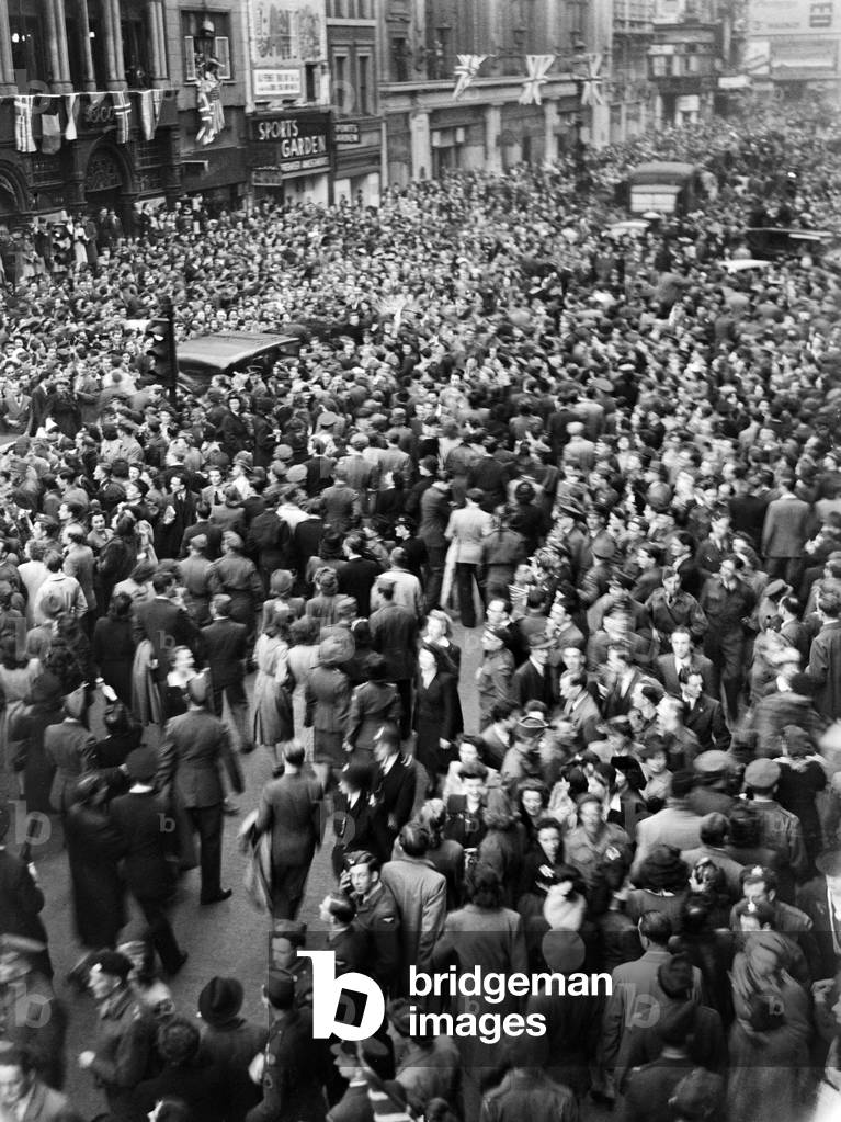 VE Day celebrations in London at the end of the Second World War. Huge crowds gathered around Piccadilly Circus during the celebrations., 8th May 1945 (b/w photo)