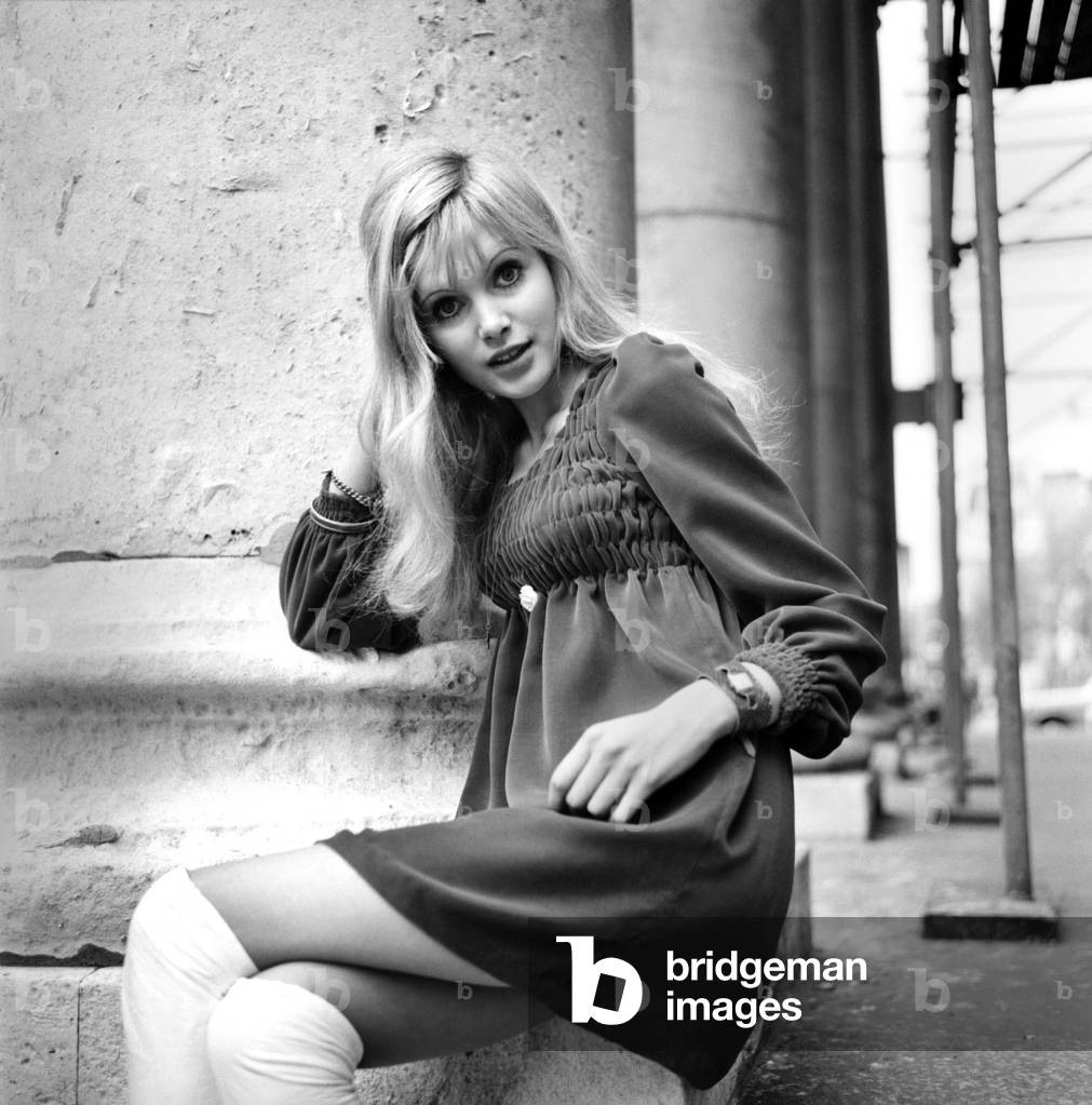 Actress and model Maddy Smith a.k.a. Madeline Smith aged 20 photographed in London wearing a black dress and white knee high boots
November 1969