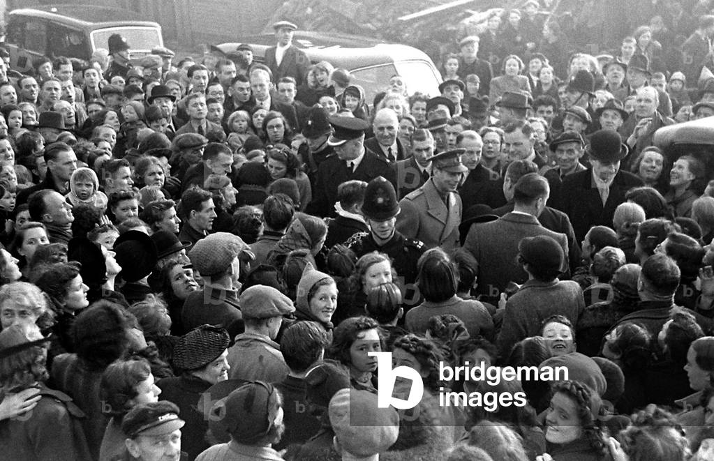 Crowds gather to greet King George VI on his visit to Birmingham to survey the bomb damage after a bombing raid in world War Two, c. 1944 (b/w photo)
