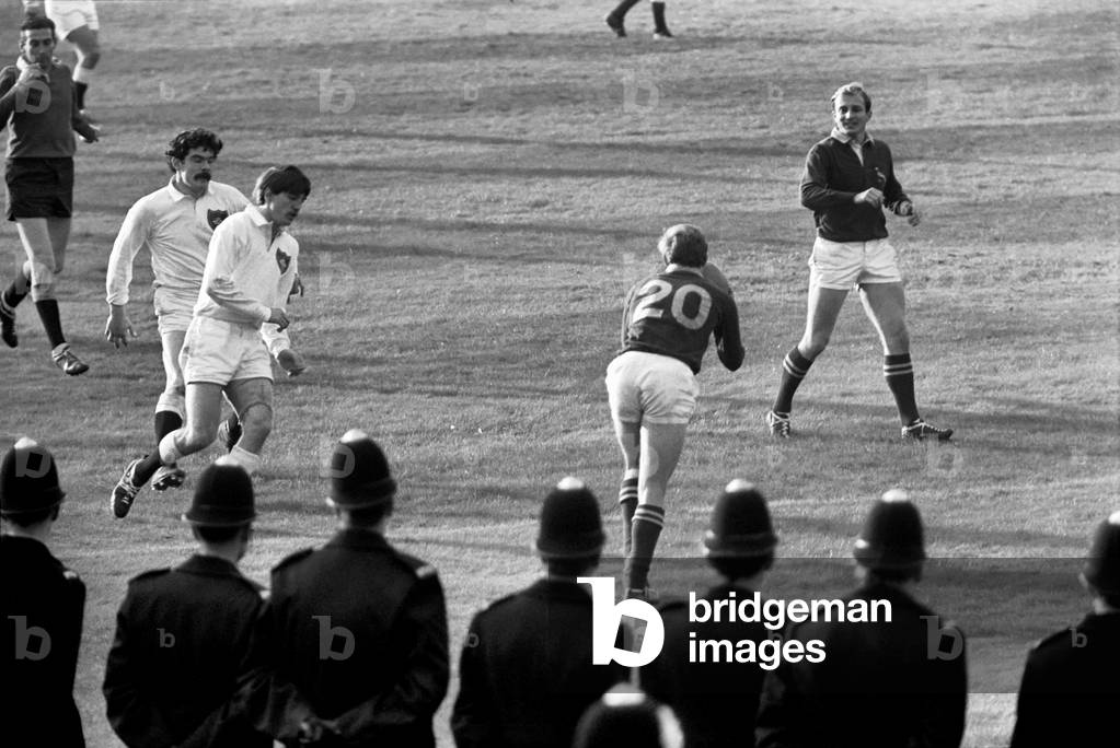 South Africa rugby team visit to Britain. Police on guard as the action goes on the pitch. 
November 1969
