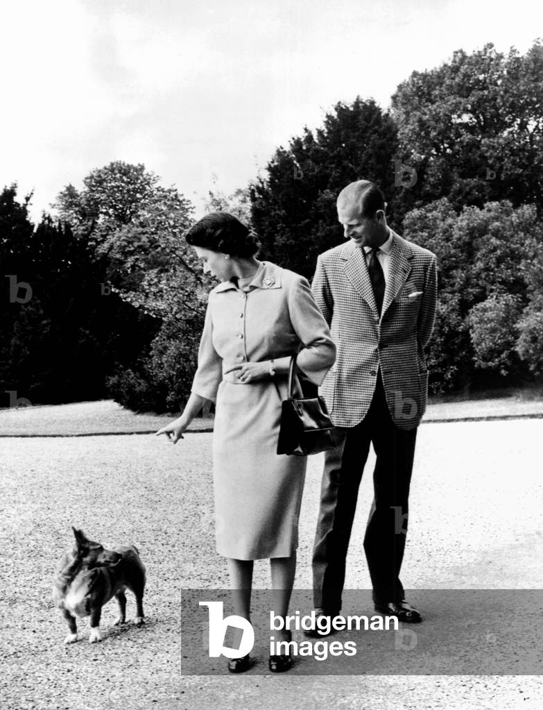 Queen Elizabeth II, Princess Elizabeth with Prince Philip at Windsor Castle - The Queen talks to her corgi, Sugar, 04/06/1959 (b/w photo)