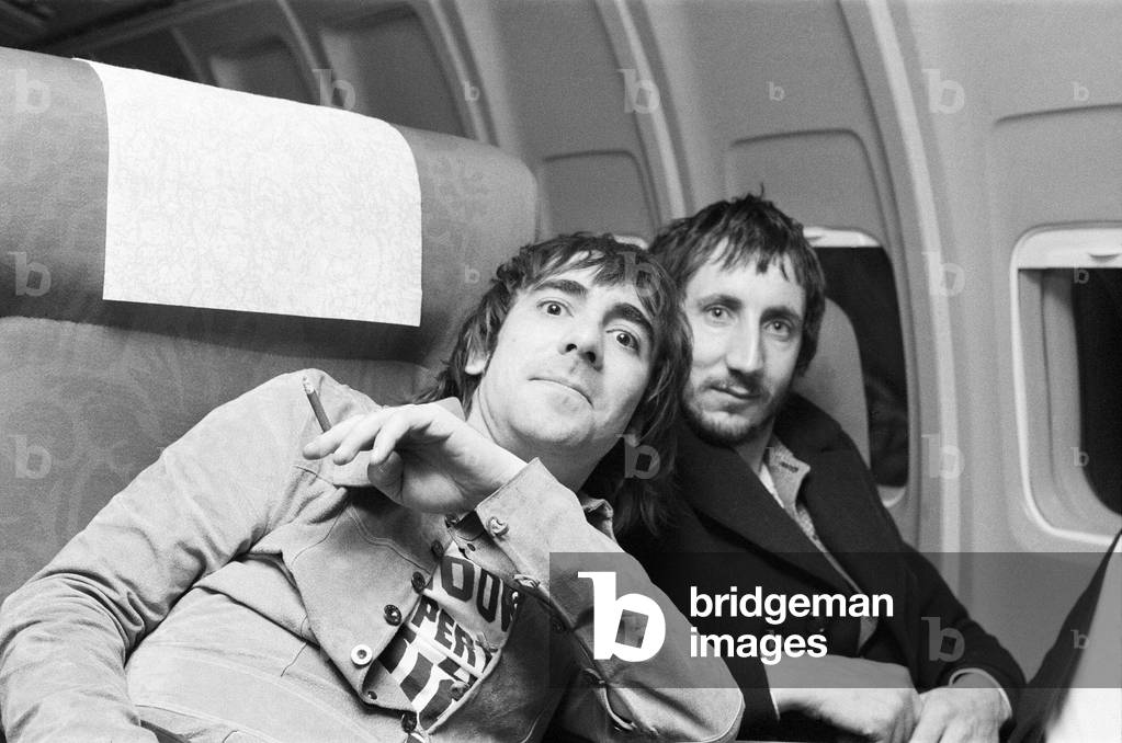 Members of The Who rock group. Drummer Keith Moon and guitarist Pete Towshend on their plane for the flight home. 8th December 1973 (b/w photo)