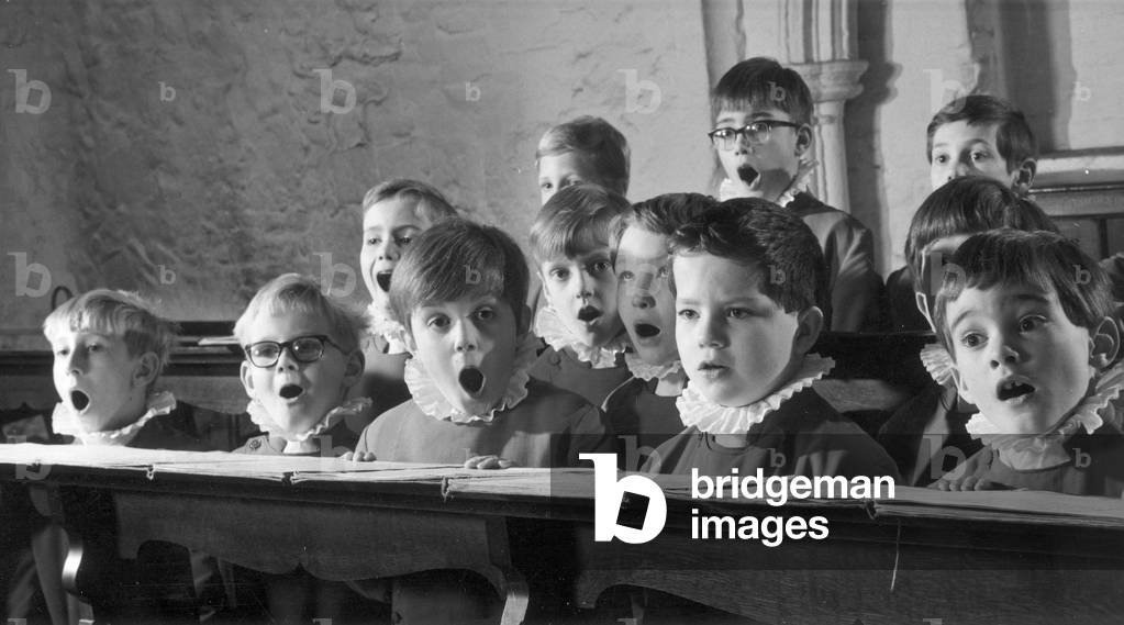 Young probationers at the Westminster Abbey School Choir sing a hymn during choir practice, 1st December 1972 (b/w photo)