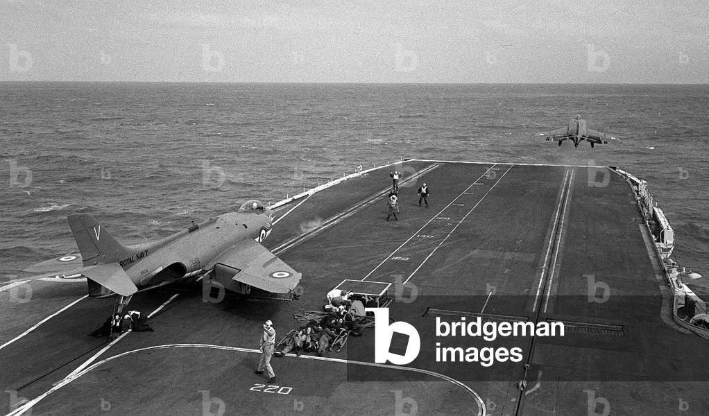 Fleet Air Arm Supermarine Scimitar aircraft 1959, waits to launch off the deck of Royal Navy Aircraft Carrier HMS Victorious as another aircraft take to the air using the steam catapult, 1959 (b/w photo)