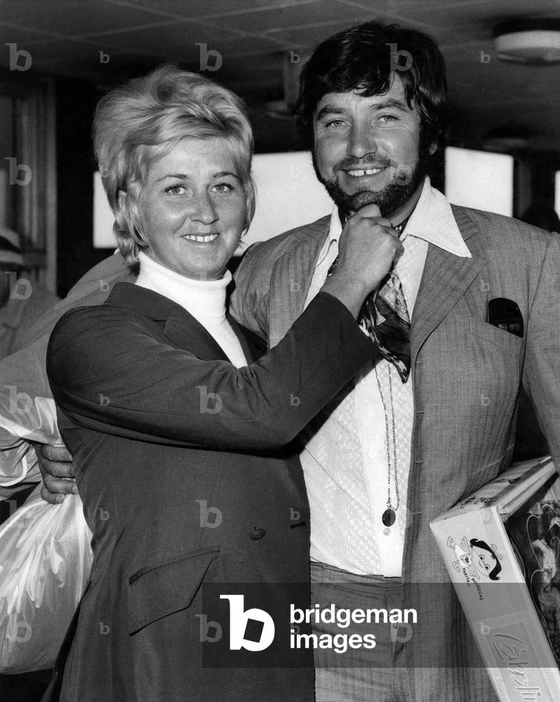 Comedian Jimmy Tarbuck flew into London airport today sporting a beard. With his wife, Pauline, October 1969 (b/w photo)