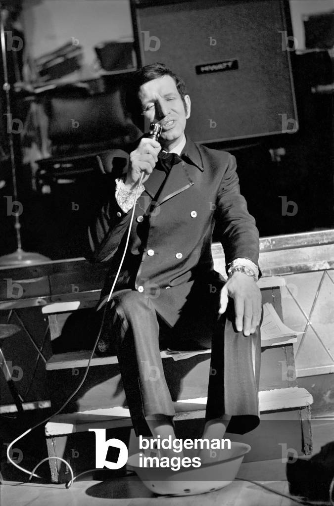 Cabaret artist and Britain's top singing coach Bob Anthony is performing a non-stop singing marathon in aid of charity. After training for 10 years, 18 hours a day, Bob realises his life's ambition and will show the world his modern singing and breathing techniques which hitherto have not been practised by any singer.
With over 15 hours on his feat. Bob Anthony relaxes with his feet in a bowl of water on stage at the Lyceum - still singing. 
November 1969