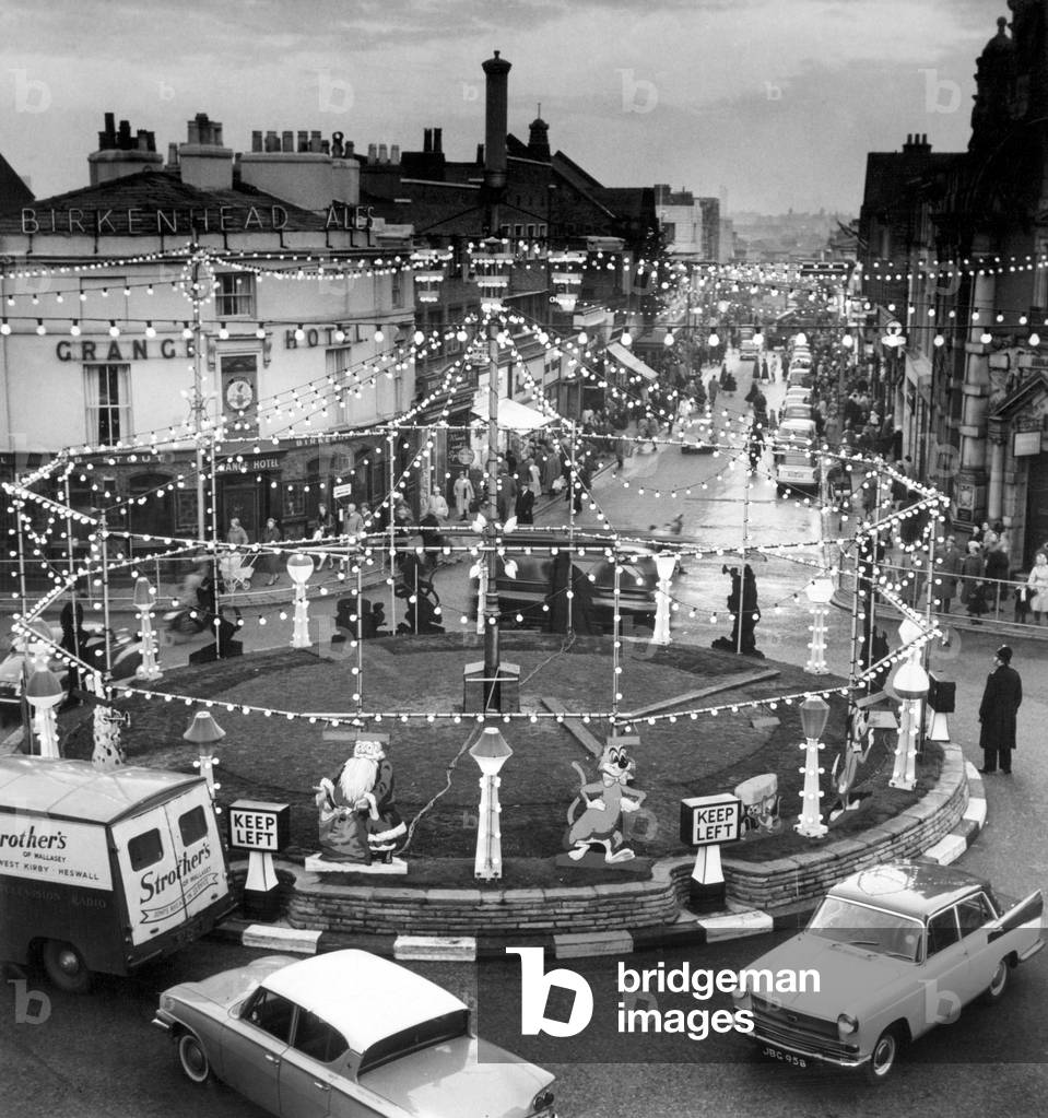 A showpiece of the Birkenhead illuminations, a traffic island in Grange Road with hundreds of lights and animals. Wirral, Merseyside, 30th November 1961 (b/w photo)