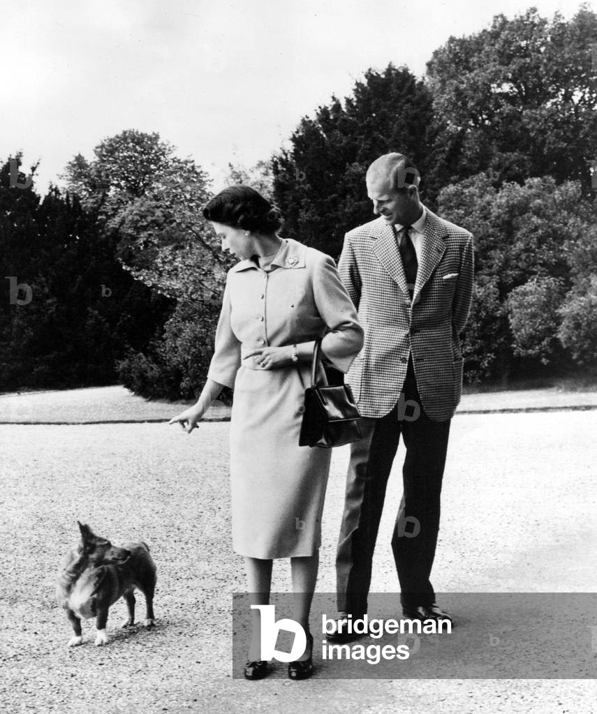 Queen Elizabeth II, Princess Elizabeth with Prince Philip at Windsor Castle - The Queen talks to her corgi, Sugar, 04/06/1959
