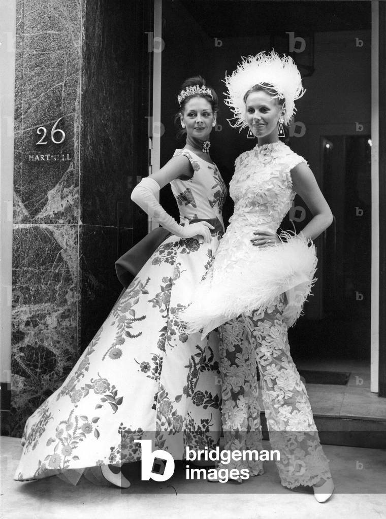 Evening outfits designed by Norman Hartnell, modelled by Diana, left, and Vivian
