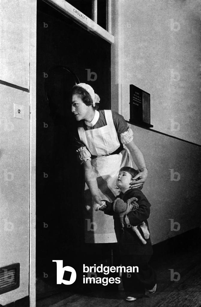 Nurse with young child at university hospital. October 1943