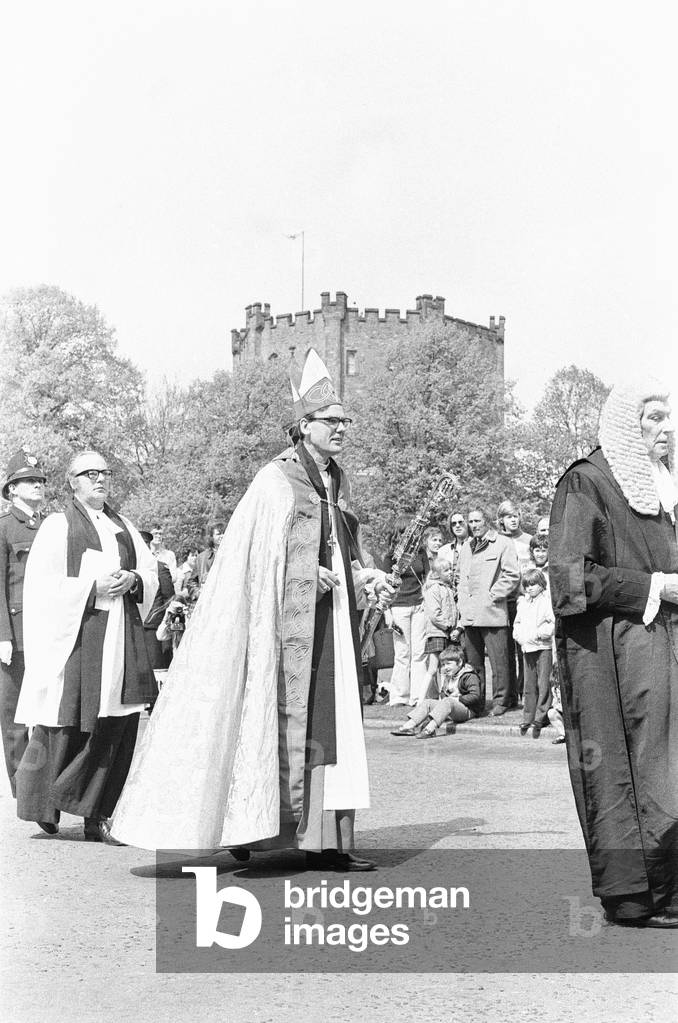 The Rt Revd Dr John Habgood the Bishop of Durham strikes the doors of the Cathedral with his staff. 20th May 1979 (b/w photo)