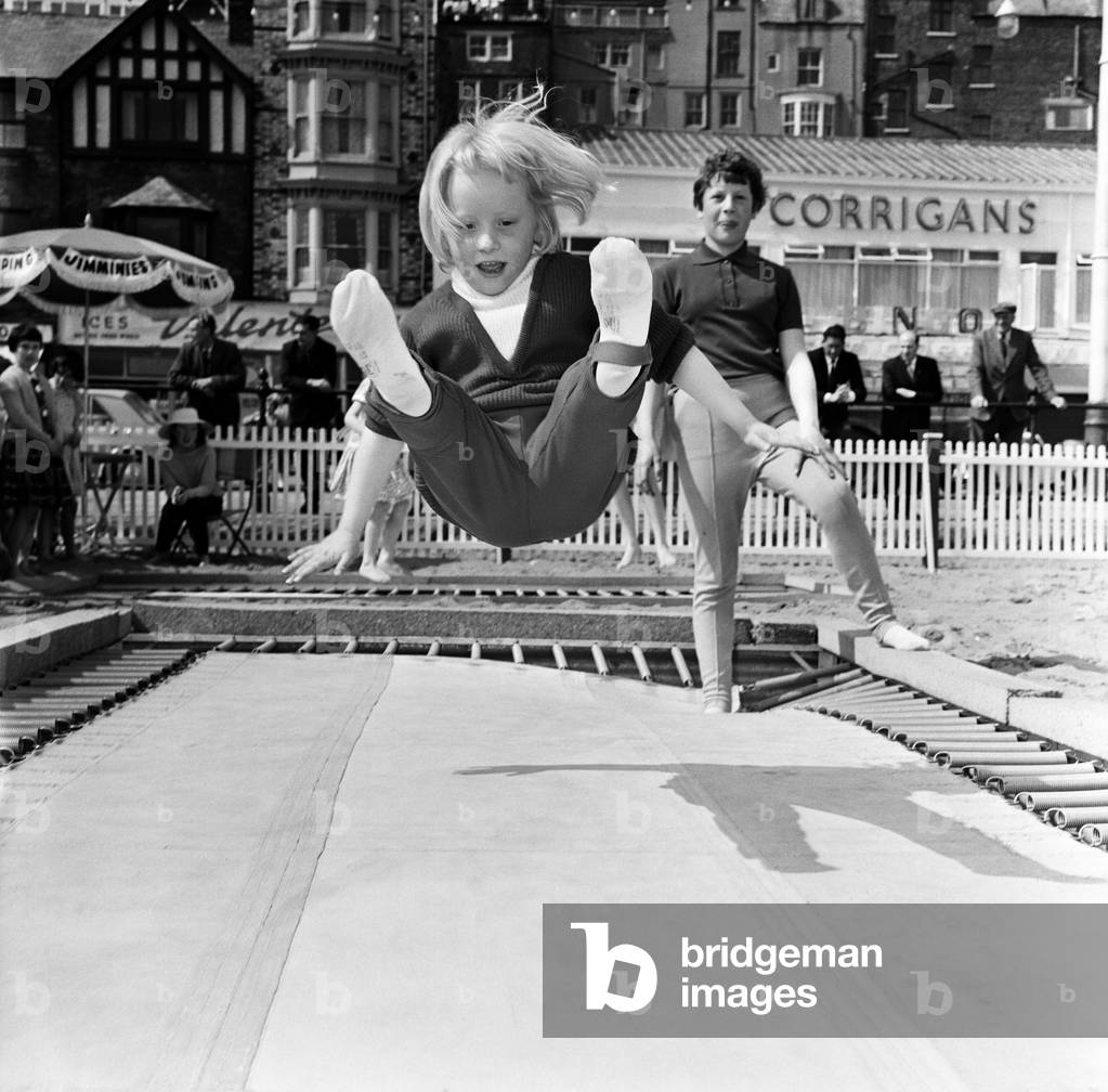 Trampoline on the sands at Scarborough, North Yorkshire. Pictured is Janette Gildersleeve, aged 6, 14th May 1963.