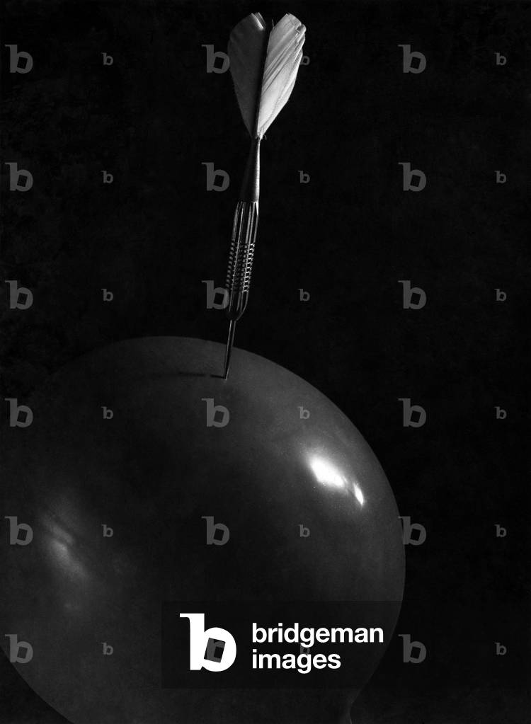 Death of a balloon. A dart about to puncture the surface
1947