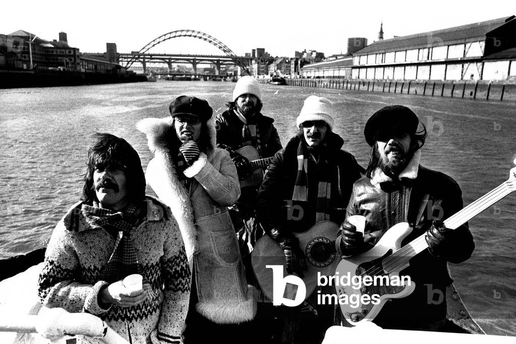 Lindisfarne sailed down the Tyne on a musical journey. The group were filming on board a Tyne ferry for a half-hour television show called 'All Right Now'. (Left to right) Ray Jackson, Ray Laidler, Si Cowe, Alan Hull and Rod Clements, 4th March, 1979 (b/w photo)