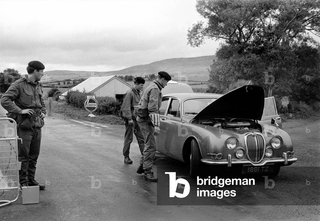 Soldiers carry out a search for weapons and explosives at the army check point at Buncrana border crossing, Northern Ireland. July 1970 70-7160-002