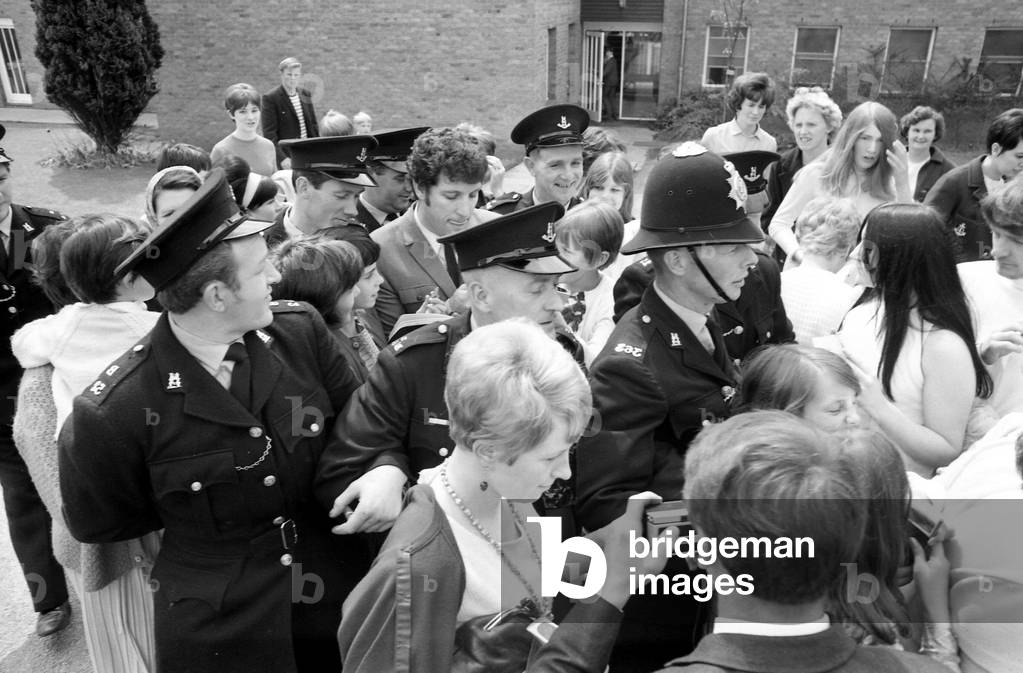 Welsh singer Tom Jones visited Corley Residential School's garden fete in Coventry and was presented with a silver tankard. The money raised at the fete will go to building a swimming pool at the school for delicate children. 10th June 1967 (b/w photo)