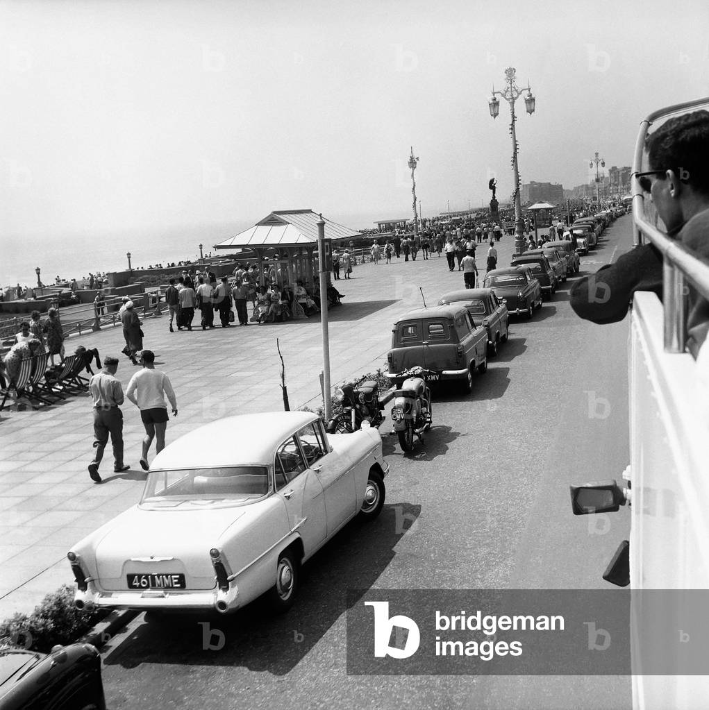 Traffic, parked cars, street scene, Brighton, East Sussex. June 1960 (b/w photo)