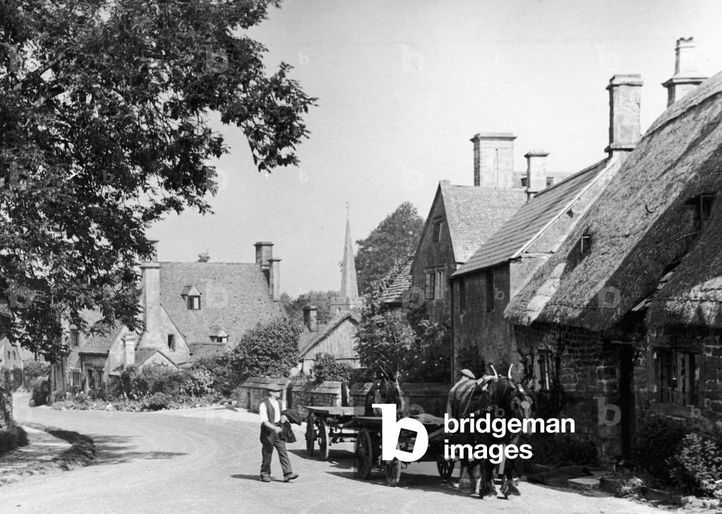 Man with his horse and cart on a country road in the Cotswold village of Stanton, Gloucestershire, c. 1935 (b/w photo)