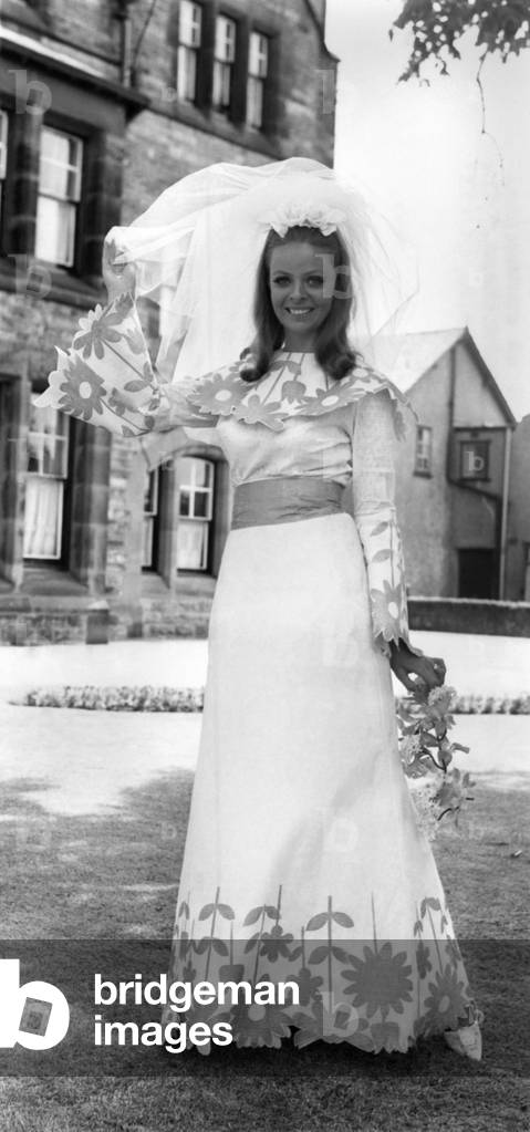 Fashion 1960's: Here comes the Bride in Paper. Confetti is thrown away at weddings - so why not a throwaway wedding dress? And here's the ripping answer modelled by 23-year-old Jenny Crowe - a paper gown which won't break a girl's piggy bank at 37s. The manufacturers from Crosby, near Liverpool, say: 
