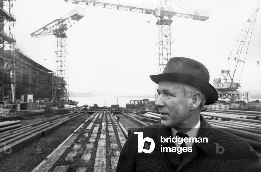 Cunard's naval architect Dan Wallace, of Clydebank, stands at the empty berth which will house the Q4 - later named the QE2 - his ten year dream. Circa 1965 (b/w photo)